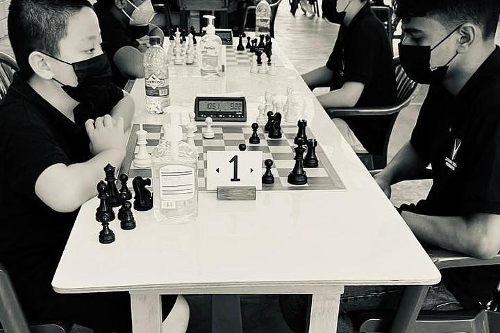 Students playing chess during a classroom training session.