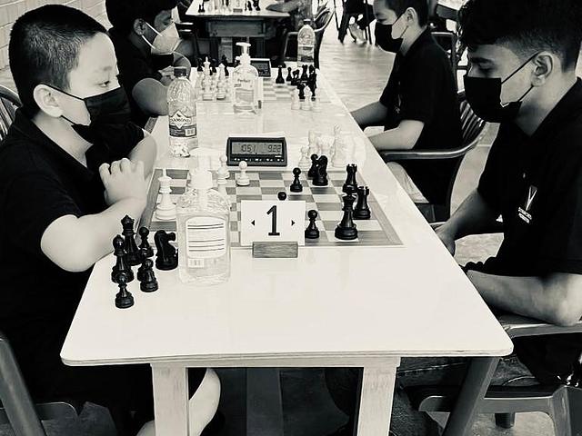 Students and teachers participating in a school chess session.